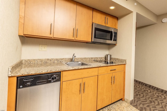 kitchen featuring sink, light stone counters, and stainless steel appliances