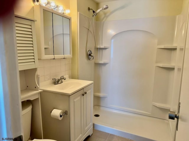 full bath featuring tile patterned floors, a shower, decorative backsplash, and vanity