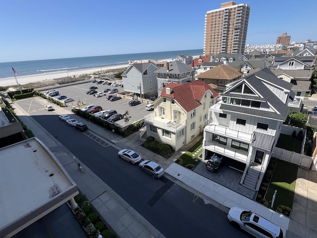 birds eye view of property with a beach view and a water view