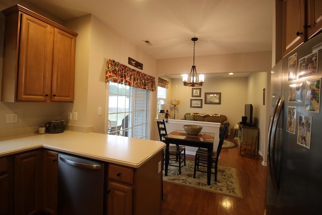 kitchen with dark wood-type flooring, an inviting chandelier, refrigerator, dishwasher, and kitchen peninsula