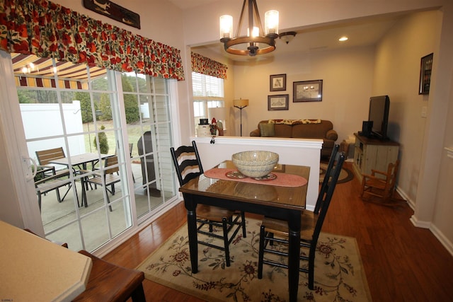 dining space featuring an inviting chandelier and hardwood / wood-style flooring