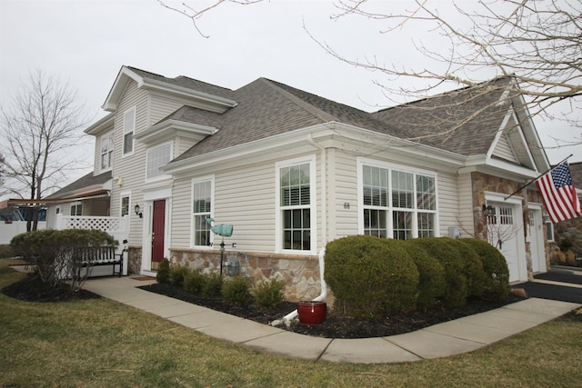 view of property exterior with a garage and a yard