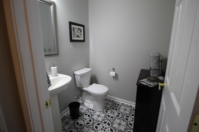 bathroom featuring tile patterned flooring, sink, and toilet