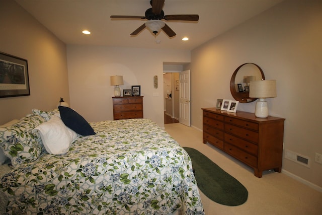 bedroom with ceiling fan and light carpet