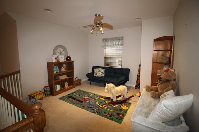 carpeted living room with ceiling fan