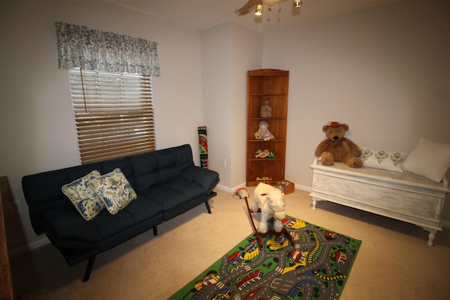 carpeted living room with ceiling fan