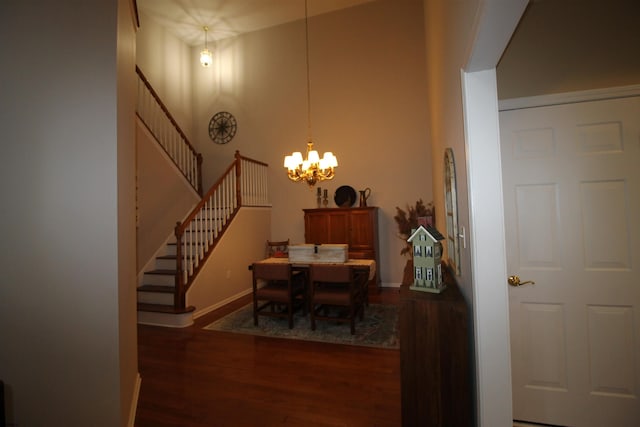 dining space with dark hardwood / wood-style flooring and a notable chandelier