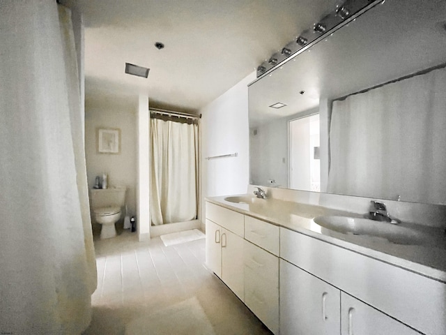 bathroom featuring toilet, walk in shower, and vanity