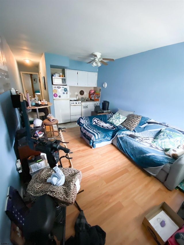 living room featuring ceiling fan and light hardwood / wood-style flooring