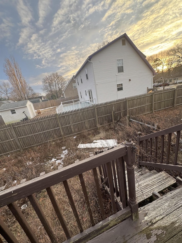 property exterior at dusk with a deck