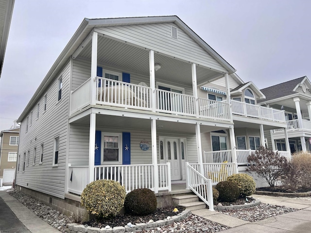 view of front of property featuring a balcony and a porch