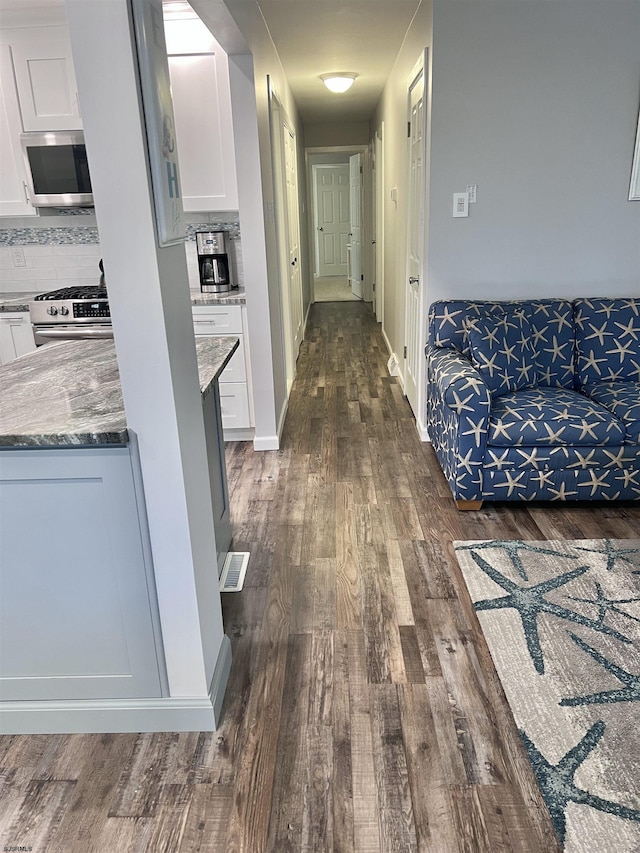 hall with dark wood-type flooring