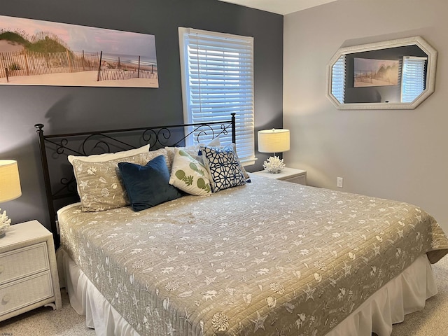 bedroom featuring light colored carpet