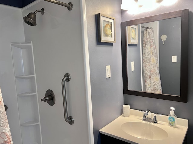 bathroom with walk in shower and vanity