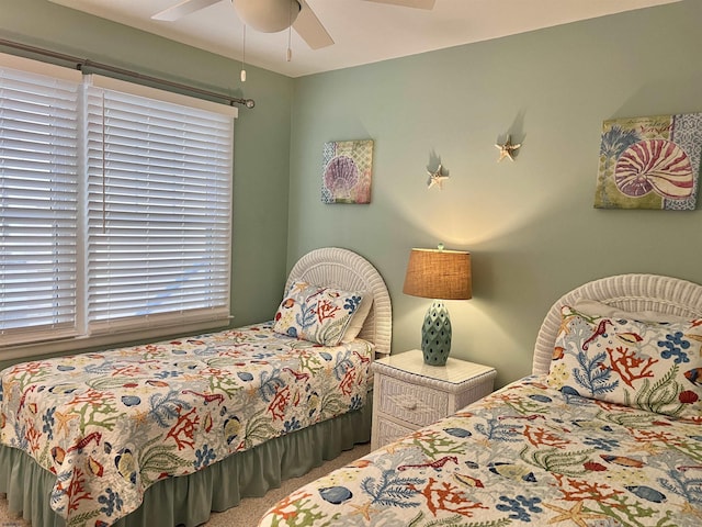 bedroom with ceiling fan and carpet flooring