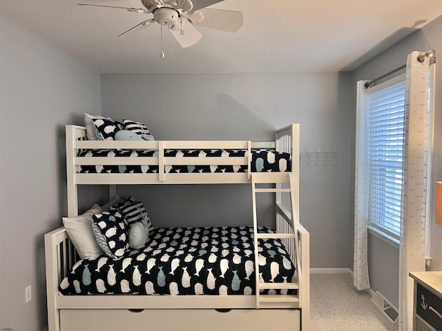 bedroom featuring ceiling fan and carpet