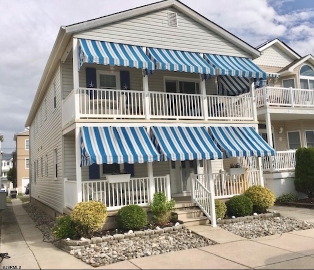 view of front facade featuring a balcony and a porch