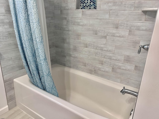 bathroom featuring shower / bathtub combination with curtain