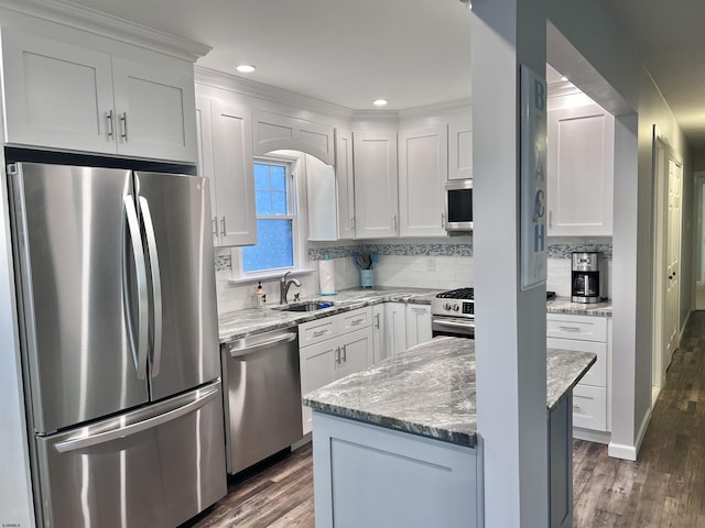 kitchen featuring dark hardwood / wood-style floors, sink, stainless steel appliances, and white cabinetry