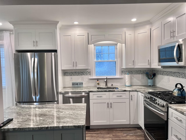 kitchen featuring dark wood-type flooring, white cabinetry, stainless steel appliances, sink, and light stone counters