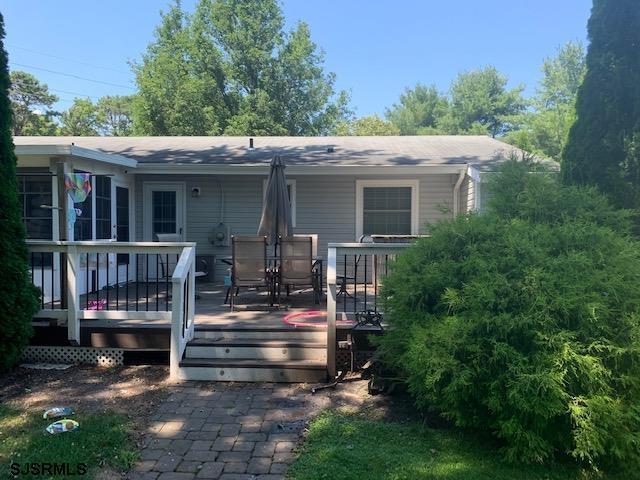 rear view of house featuring a deck