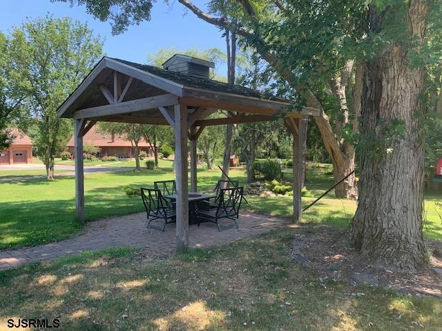 view of community featuring a gazebo, a yard, and a patio