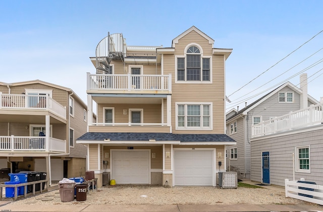 view of front of house with central AC and a garage