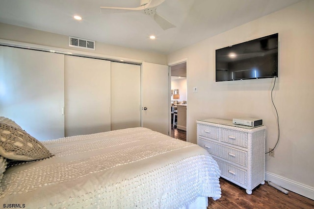 bedroom featuring ceiling fan, a closet, and dark hardwood / wood-style flooring