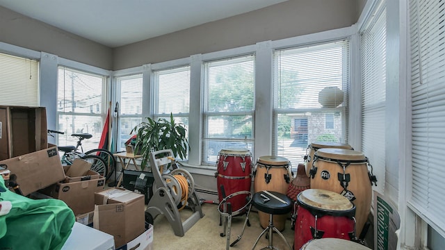 sunroom with a baseboard heating unit