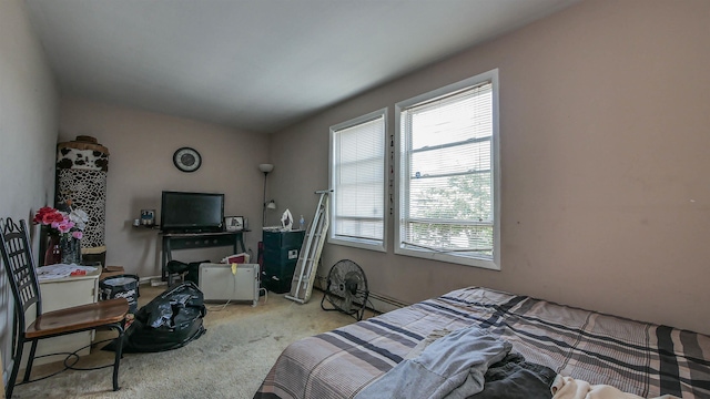 bedroom with light carpet and multiple windows