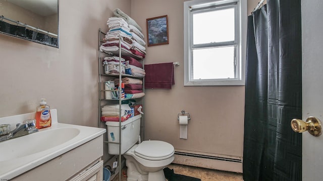 bathroom featuring a baseboard heating unit, vanity, and toilet