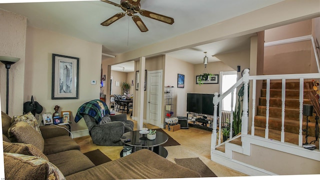 carpeted living room with ceiling fan