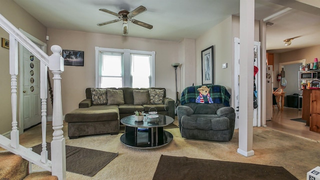 carpeted living room with ceiling fan