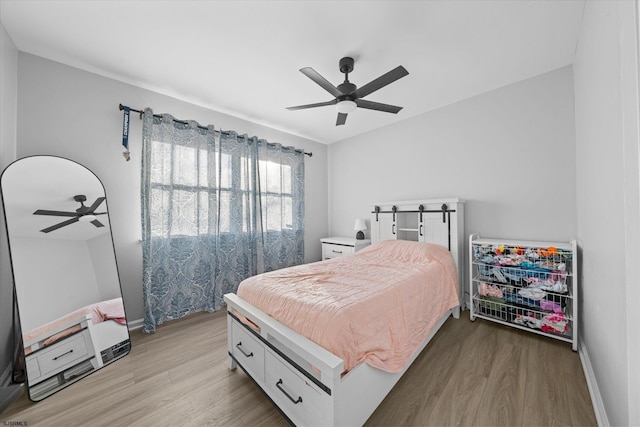 bedroom featuring ceiling fan and light hardwood / wood-style flooring