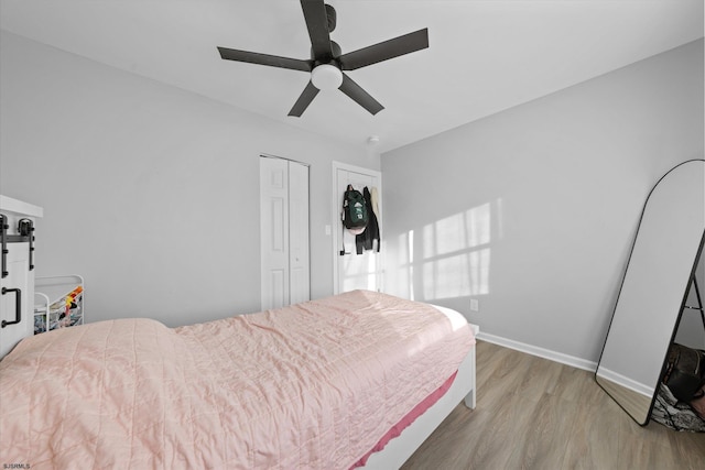 bedroom featuring ceiling fan, light hardwood / wood-style floors, and a closet