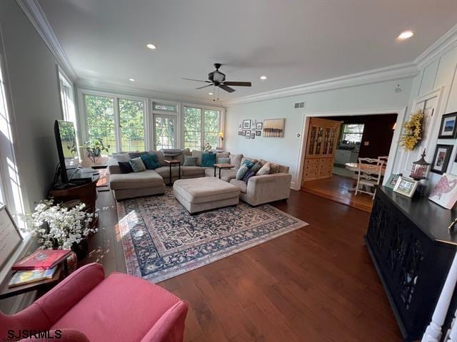 living room with ceiling fan, dark hardwood / wood-style floors, and ornamental molding