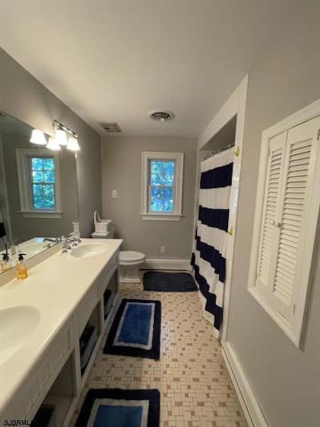 bathroom with toilet and vanity