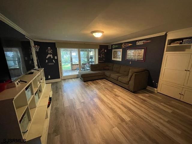 living room with hardwood / wood-style flooring and ornamental molding