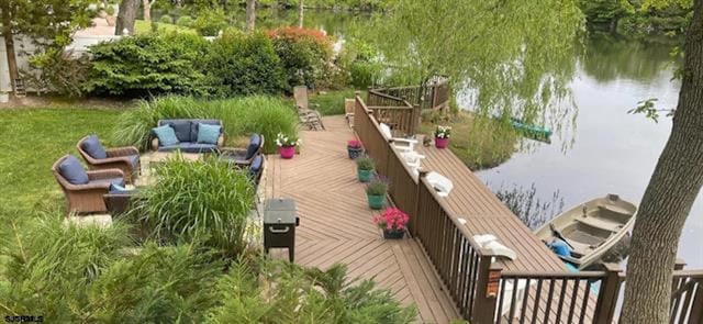 view of dock featuring outdoor lounge area and a deck with water view