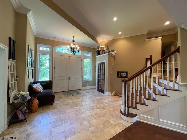 entryway with a chandelier and ornamental molding