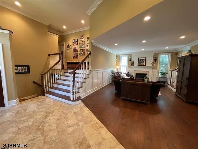 interior space featuring hardwood / wood-style floors and crown molding