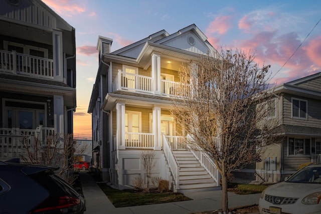 view of front of house featuring a balcony and a porch