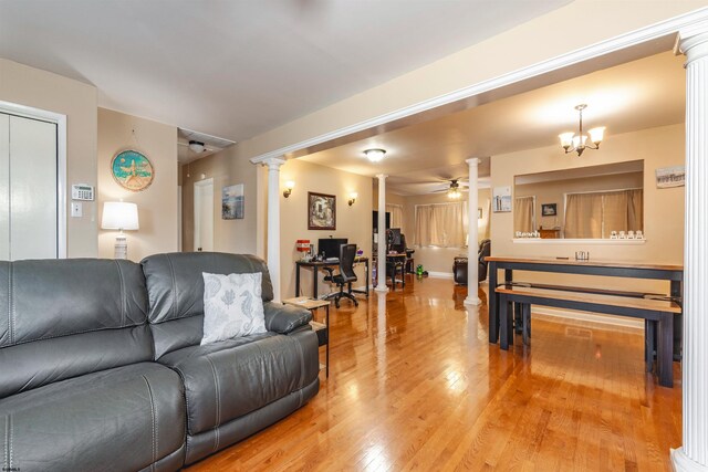 living room with ceiling fan, ornate columns, and light wood-type flooring