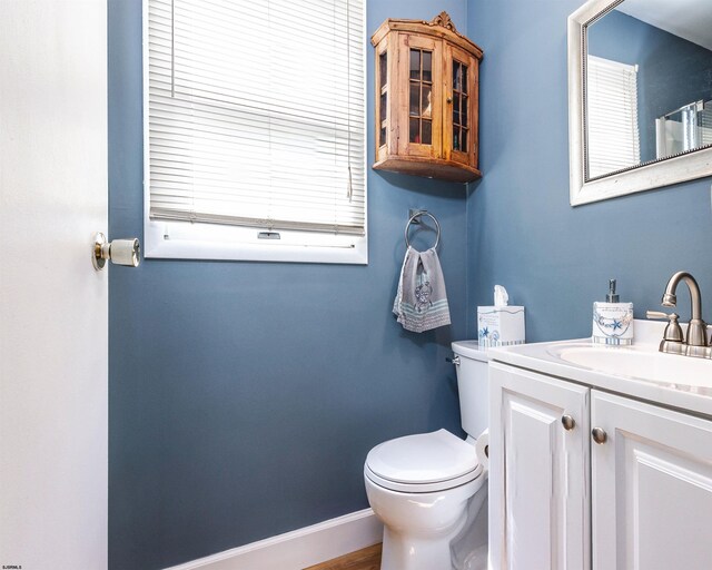 bathroom featuring toilet and vanity