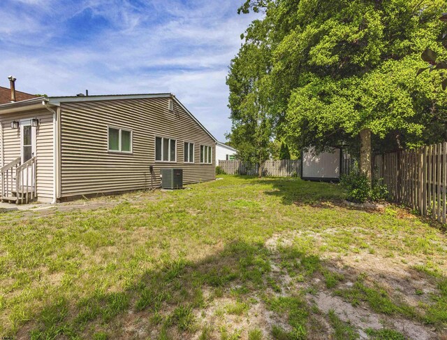 view of yard featuring cooling unit and a storage unit