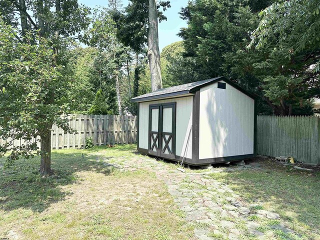 view of outbuilding featuring a lawn