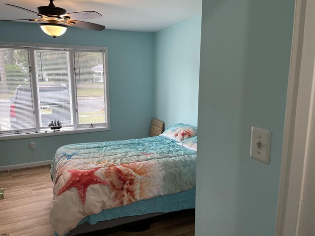 bedroom featuring ceiling fan and hardwood / wood-style floors