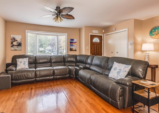 living room featuring ceiling fan and light hardwood / wood-style floors