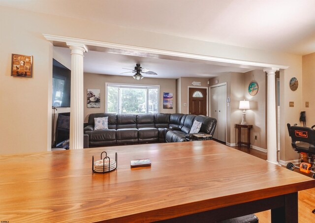 living room with ceiling fan, light hardwood / wood-style flooring, and ornate columns