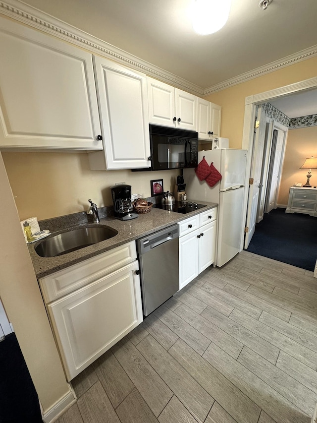 kitchen with black appliances, white cabinetry, dark stone counters, sink, and crown molding